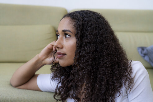 Young woman sitting at home, thinking - HHLMF00329