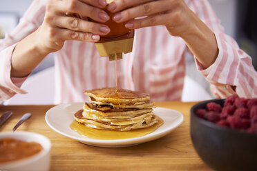 Young woman having sweet pancakes for breakfast, close up - ABIF00929