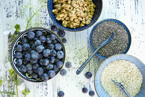 Bowls of granola, blueberries, black chia seeds and amaranth stock photo