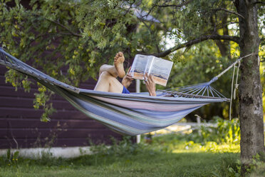 Woman reading in a hammock - AURF01622