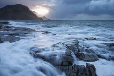 Waves crash over rocky coast of Vestv├Ñg├©y during winter storm, Lofoten Islands, Norway - AURF01681