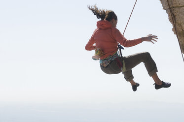 A woman falling off a rock climb at Windy Point, Mount Lemmon Highway, Coronado National Forest, Tucson, Arizona. - AURF01829