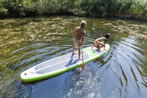 Two girls in a pond on SUP board - TCF05727