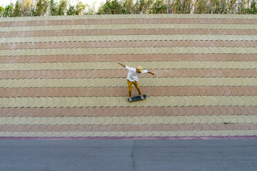 Junger Mann fährt auf einem Skateboard an einer Wand - AFVF01495