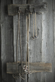 Old ski poles hanging on rustic wooden wall - ASF06220