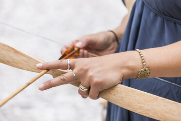 Close-up of archeress holding bow and arrow - TCF05784