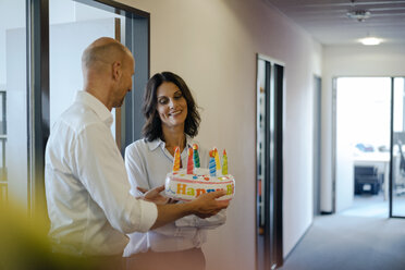 Geschäftsmann beschenkt seinen Kollegen mit einer Geburtstagstorte im Büro - KNSF04522
