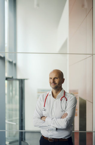 Doctor standing in hospital with stethoscope around his neck stock photo