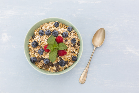 Bowl of muesli with raspberries and blueberries stock photo