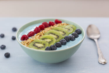 Smoothie bowl with blueberries, raspberries, kiwi and chopped hazelnuts - JUNF01097