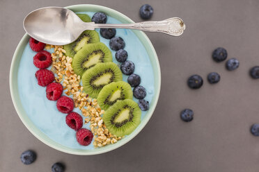 Smoothie bowl with blueberries, raspberries, kiwi and chopped hazelnuts - JUNF01098