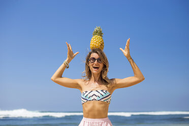 Young woman playing with pineapple - AURF02195