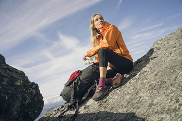 Woman hiking on a rocky ridgeline in New England. - AURF02204