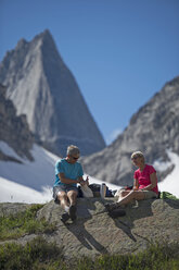 Couple stops for lunch under a huge granite mountain. - AURF02331