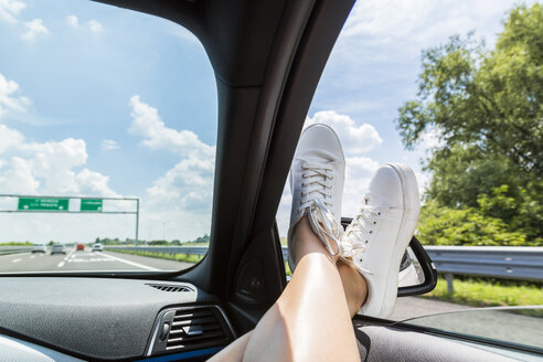 Italy, feet of woman leaning out of car window - JUNF01139
