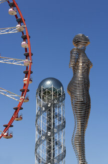 Georgia, Adjara, Batumi, Miracle Park, Alphabetic Tower and ferris wheel with Alin and Nino sculpture in foreground - WWF04360