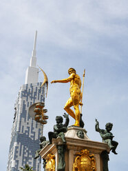 Georgia, Adjara, Batumi, Golden sculpture on the Neptune fountain with technical university in background - WWF04370