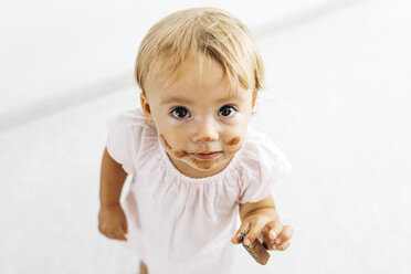 Portrait of little girl eating chocolate cookie - JRFF01810