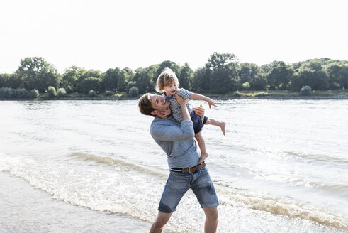 Father and son having fun at the riverside - UUF15008