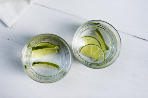 Two glasses of water with sliced limes - RAMAF00040