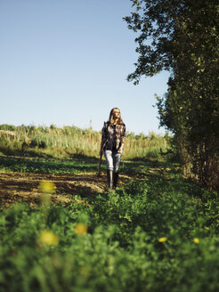 Farmer walking on a field - RAMAF00048