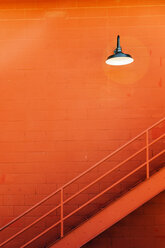 Metal stairway and orange wall. - AURF02409