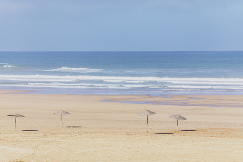 Marokko, leerer Strand, Strohsonnenschirme, lizenzfreies Stockfoto