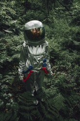 Spaceman exploring nature, looking at forest - VPIF00537
