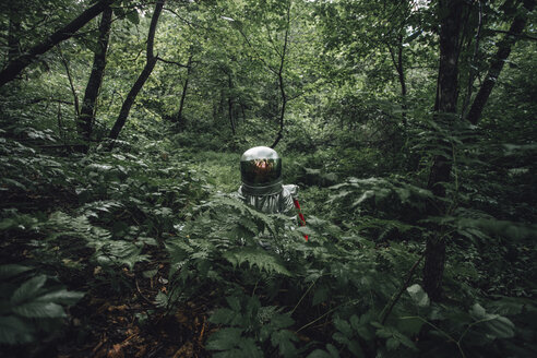 Spaceman exploring nature, looking at forest - VPIF00539