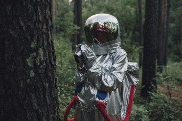 Spaceman exploring nature, filming trees - VPIF00568