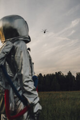 Spaceman exploring nature, watching helicopter - VPIF00570