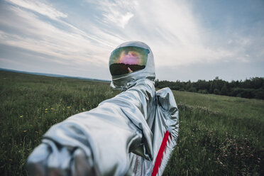 Spaceman exploring nature, reaching out hand - VPIF00588