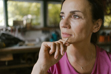 Portrait of mature woman in her workshop thinking - KNSF04687