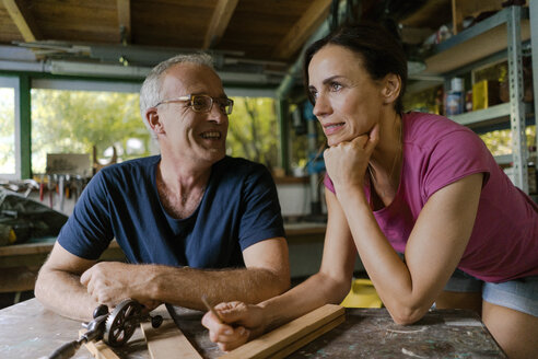 Smiling mature couple in workshop - KNSF04691