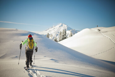 A female snowshoer on ridgeline. - AURF02632