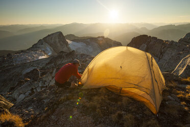Ein Wanderer schlägt sein Zelt auf dem Gipfel des Saxifrage Peak in Pemberton, Kanada, auf. - AURF02644