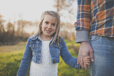 A father holds hands with his daughter. - AURF02646