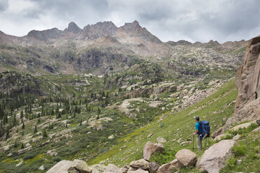 A hiker looks out over the Weminuche Wilderness backcountry. - AURF02661