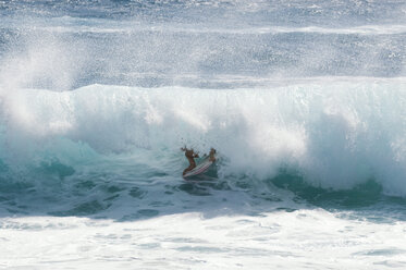 A man gets barreled in brutal shore break of Sandy Beach, Oahu, Hawaii. - AURF02728