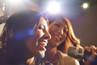 Two women singing karaoke. - AURF02806