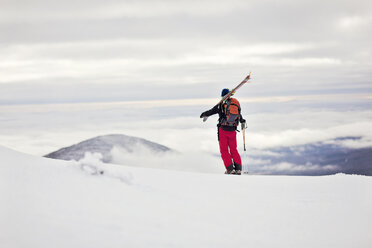 A backcountry skier takes in the view from Burnt Mountain, Maine. - AURF02891