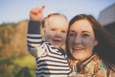 A young mother holds her baby daughter. - AURF02980