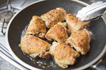 Chicken thighs in a frying pan - AURF03019
