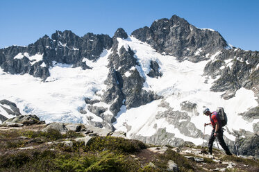Climber traversing in front of Mount Formidable during the Ptarmigan Traverse - AURF03080