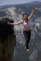 Emily Sukiennik walking a highline above the Yosemite Valley floor at Taft Point - AURF03106