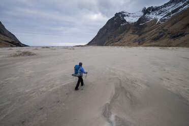 Rucksacktouristin läuft über den weiten Sand des Horseid-Strandes, Moskenes├©y, Lofoten, Norwegen - AURF03111