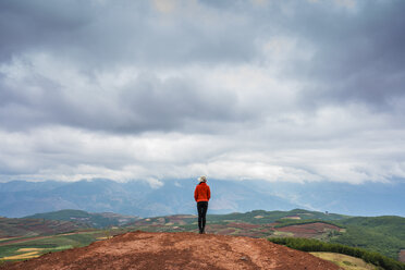 China, Yunnan province, Dongchuan, Red Land, young woman standing on viewpoint - KKAF01537