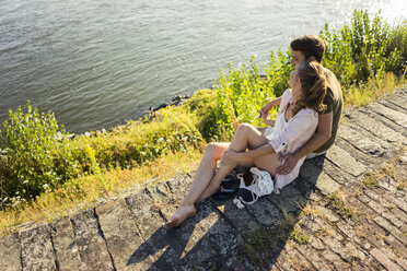 Happy couple relaxing at the riverside in summer - JOSF02571