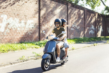 Couple riding motor scooter in summer - JOSF02604