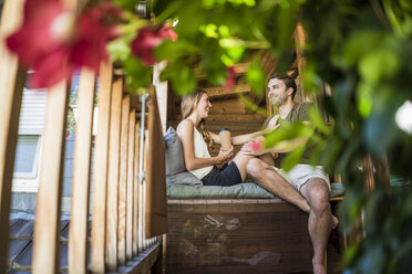 Happy couple relaxing on balcony - JOSF02639